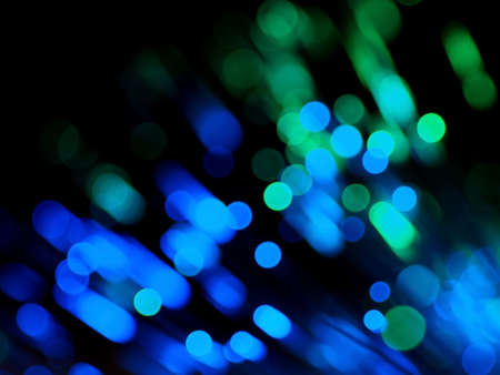 Blue and green abstract background consisting of blurred lines and circles