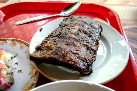 hot, freshly baked barbecue ribs on a plateの写真素材