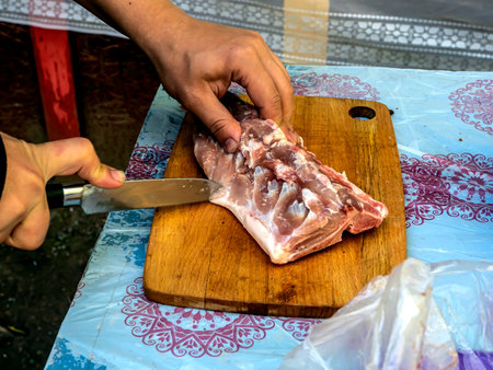 cutting raw meat for cooking shish kebab, cook's hands are visibleの写真素材