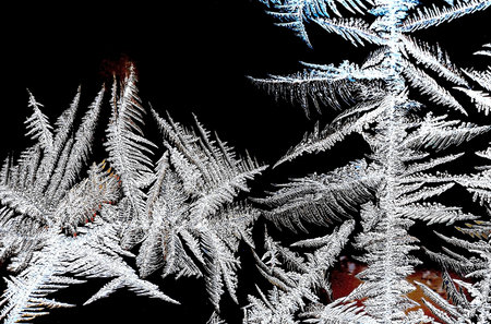 abstract frosty patterns on the window glass in the form of multipath starsの写真素材
