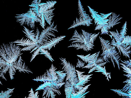 abstract frosty patterns on the window glass in the form of multipath starsの写真素材