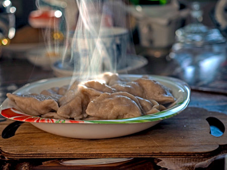 a plate of mouth-watering hot dumplings, steam rises above the plate