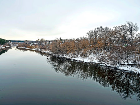 banks of the winter river covered with forestの写真素材