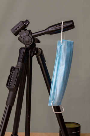 photo tripod with a mask hanging on the handle
