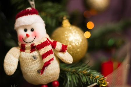 Snowman ornament on a christmas treeの写真素材