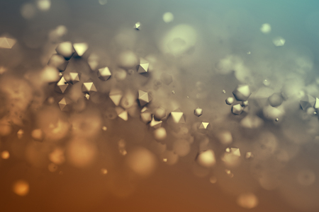 Abstract 3d rendering of chaotic low poly particles. Flying polygonal spheres in empty space. Futuristic background with bokeh effect. Poster design.の写真素材