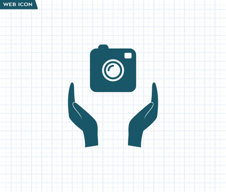 Photo camera icon. Camera in hand Photography. Flat design.のイラスト素材
