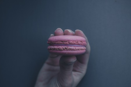 girl holding cookie on a blue backgroundの写真素材