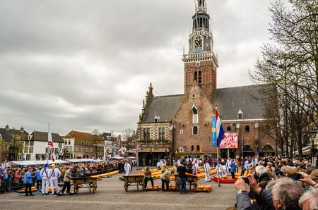 ALKMAAR, THE NETHERLANDS - APRIL 22, 2016: Typical cheese market at the Waagplein in the city of Alkmaar (the Netherlands), one of the only four traditional Dutch cheese markets still in existence and one of the country's most popular tourist attractions.のeditorial素材