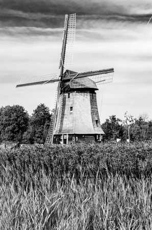 ALKMAAR, THE NETHERLANDS - AUGUST 25, 2013: Traditional Dutch windmills along the quay in Oudorp, Alkmaar (the Netherlands), built between 1627-1630. Black and white image.のeditorial素材