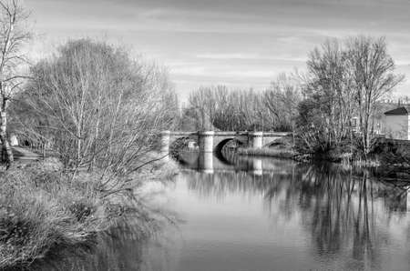 Medieval stone bridge over the Carrion River in Palencia (Castile and Leon), Spain (black and white image)の写真素材