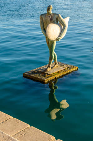ALICANTE, SPAIN - DECEMBER 30, 2018: Urban sculpture "The return of Icarus with his surfing wing" (in Spanish: "El regreso de Icaro con su ala de surf"), a work of the artist Esperanza d'Ors, located in the port of Alicante, Spain, since 1999のeditorial素材