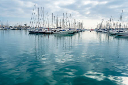 ALICANTE, SPAIN - DECEMBER 27, 2018: View of sailboats and yachts in the Mediterranean port of...