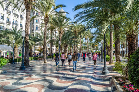 ALICANTE, SPAIN - DECEMBER 30, 2018: People walking on the Paseo de la Explanada, a promenade in the Spanish city of Alicante, one of the most popular pedestrian routes in the city.のeditorial素材