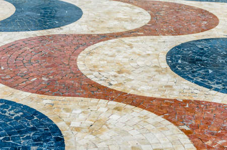 Colorful cobblestone pavement in Alicante, Spain, textured background