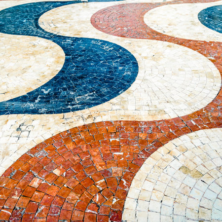 Colorful cobblestone pavement in Alicante, Spain, textured backgroundの写真素材