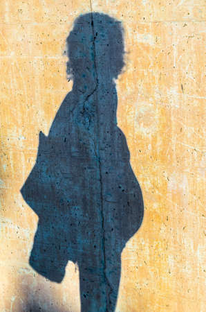 Shadow on a wall of a pregnant woman