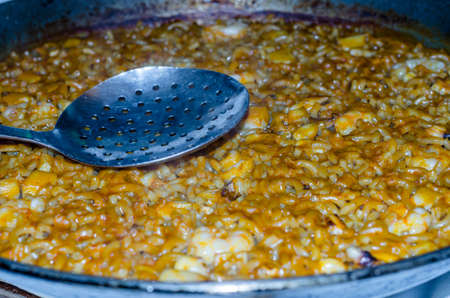 Detail of a plate of fideua, a traditional Valencian dish of seafood, similar to paella, but with noodles instead of riceの写真素材