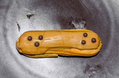 French pastry cuisine, traditional eclair on a plate