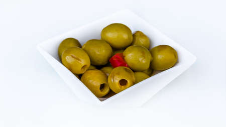 Background of green Spanish olives on white backgroundの写真素材