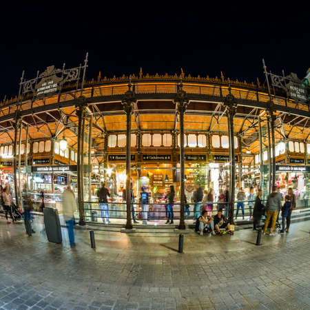 MADRID, SPAIN - OCTOBER 28, 2017: Night outside view of the "Mercado de San Miguel" (Market of San Miguel), popular among tourists, not a traditional grocery market but a gourmet tapas market, located in the center of Madrid, declared Spanish Property of のeditorial素材