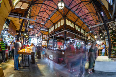 MADRID, SPAIN - AUGUST 27, 2017: People visiting and enjoying drinks and tapas inside the historical "Mercado de San Miguel" (Market of San Miguel), popular among tourists, located in the center of Madrid, Spainのeditorial素材