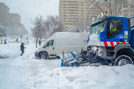 MADRID, SPAIN â€“ JANUARY 9, 2021: Snowplow clearing streets during Storm...
