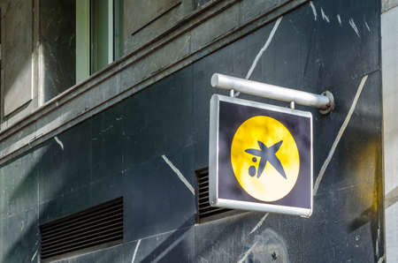 MADRID, SPAIN â€“ MAY 12, 2021: Caixabank logo on a bank branch office in Madrid, Spain....