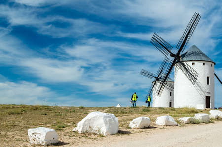 CAMPO DE CRIPTANA, SPAIN - MAY 22, 2021: Tourists visiting the typical windmills in Campo de Criptana, Spain, on the famous Don Quixote Routeのeditorial素材