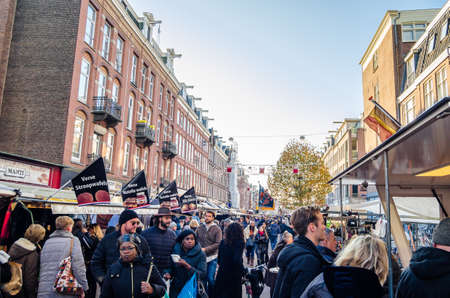 AMSTERDAM, THE NETHERLANDS - NOVEMBER 17, 2018: People visiting the Albert Cuyp Market, a street market and a tourist attraction in Amsterdam, on the Albert Cuypstraat in De Pijp area of the cityのeditorial素材