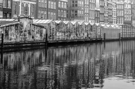 AMSTERDAM, THE NETHERLANDS - NOVEMBER 16, 2018: View of the flower market in Amsterdam, a popular tourist attraction located on the Singel canal, is the only floating flower market in the world. Black and white imageのeditorial素材