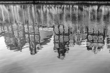 Reflection of the buildings along the canal in Amsterdam, the Netherlands. Black and white image