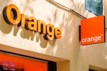 MADRID, SPAIN - JULY 23, 2021: Facade of an Orange store in Madrid, Spain, a well-known multinational telecommunications company, which provides mobile phone, internet and television servicesのeditorial素材