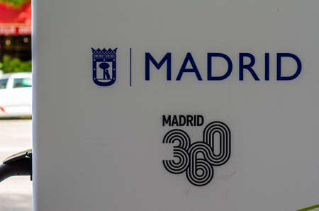 MADRID, SPAIN - JULY 23, 2021: MADRID 360 logo at an electric vehicle recharging station. MADRID 360...