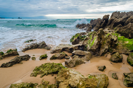 View of Valdearenas beach in Cantabria, Spain, at sunsetの写真素材