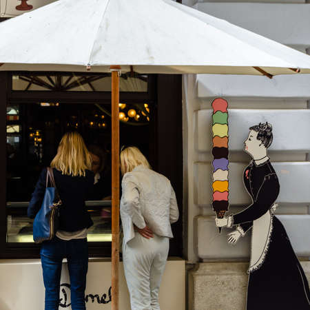 VIENNA, AUSTRIA - SEPTEMBER 1, 2013: Ice cream store front with people buying ice cream and shop logo in Vienna, Austriaのeditorial素材