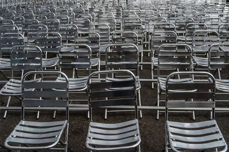 Background of several metal chairs arranged in rowsの写真素材