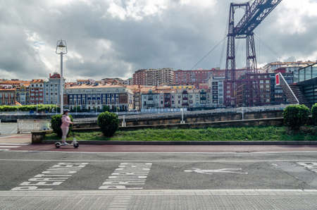GETXO, SPAIN - JULY 7, 2021: View from Getxo, Spain: the famous Vizcaya Bridge built in 1893, declared a World Heritage Site by UNESCO and the town of Portugalete in the backgroundのeditorial素材