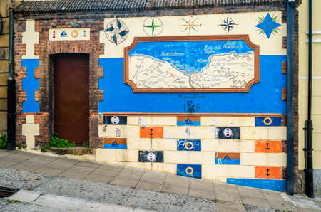 PORTUGALETE, SPAIN - JULY 7, 2021: Colorful facade, old map painted on a wall in the old town of Portugalete, Basque Country, Spainのeditorial素材