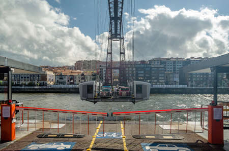 GETXO, SPAIN - JULY 7, 2021: View from Getxo, Spain: the famous Vizcaya Bridge built in 1893, declared a World Heritage Site by UNESCO and the town of Portugalete in the backgroundのeditorial素材