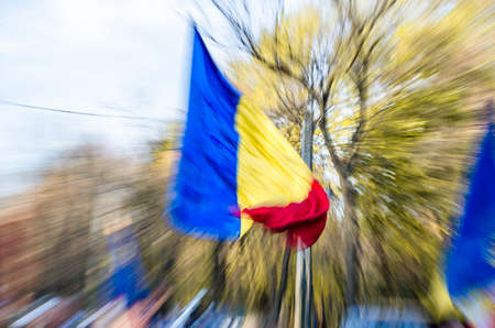 The Romanian flag carried by a person during a demonstrationの写真素材