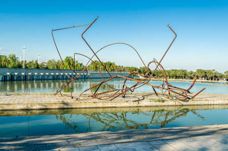 MADRID, SPAIN - MAY 4, 2021: The work "Walk between two trees" ("Paseo entre dos arboles"), an abstract sculpture by the artist Jorge Castillo, made in 1994, exhibited in the modern Juan Carlos I Park in Madrid, Spainのeditorial素材