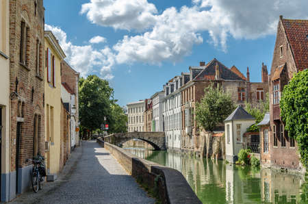 Urban landscape, buildings along the canal in Bruges, Flanders, Belgiumの写真素材