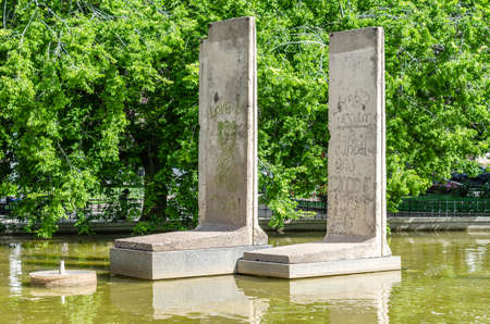 MADRID, SPAIN - MAY 8, 2021: Berlin Park in Madrid, Spain. View of a fountain with original remains of the Berlin Wall with its original paintingsのeditorial素材
