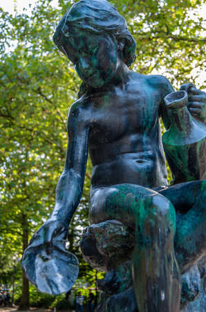 BRUSSELS, BELGIUM - AUGUST 21, 2013: Statue of a girl with a shell in its hand in Brussels Park in front of  the Royal Palace of Brussels, Belgiumのeditorial素材