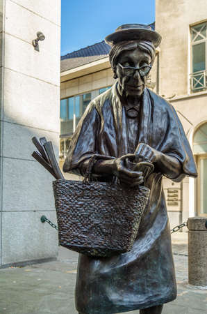 BRUSSELS, BELGIUM - AUGUST 21, 2013: Street sculpture "Madame Chapeau" by Tom Frantzen in Brussels, Begium. The sculpture depicts an old woman who is counting her moneyのeditorial素材