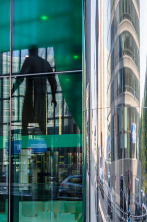 BRUSSELS, BELGIUM - AUGUST 21, 2013: Modern statue "Stepping Forward", an imposing bronze sculpture of a man walking, made by sculptor Hanneke Beaumont in 2007, located in the front of The Council of the European Union in the European Quarter of Brussels,のeditorial素材