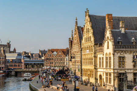 GHENT, BELGIUM - AUGUST 20, 2013: Urban landscape, people enjoying a beautiful summer afternoon in Graslei, a quay in the historic city center of Ghent, Belgium. Part of the medieval port, now is a cultural and touristic hotspot of the city, with a high cのeditorial素材