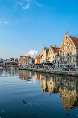 GHENT, BELGIUM - AUGUST 20, 2013: Urban landscape, people enjoying a beautiful summer afternoon in Graslei, a quay in the historic city center of Ghent, Belgium. Part of the medieval port, now is a cultural and touristic hotspot of the city, with a high cのeditorial素材