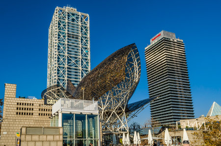 BARCELONA, SPAIN - DECEMBER 8, 2013: View of the sculpture "Peix" (Fish in Catalan) in Barcelona, Spain, made by Frank Gehry in 1992 for the Olympic Games, located in the Olympic Port, next to the Arts and Mapfre Towersのeditorial素材